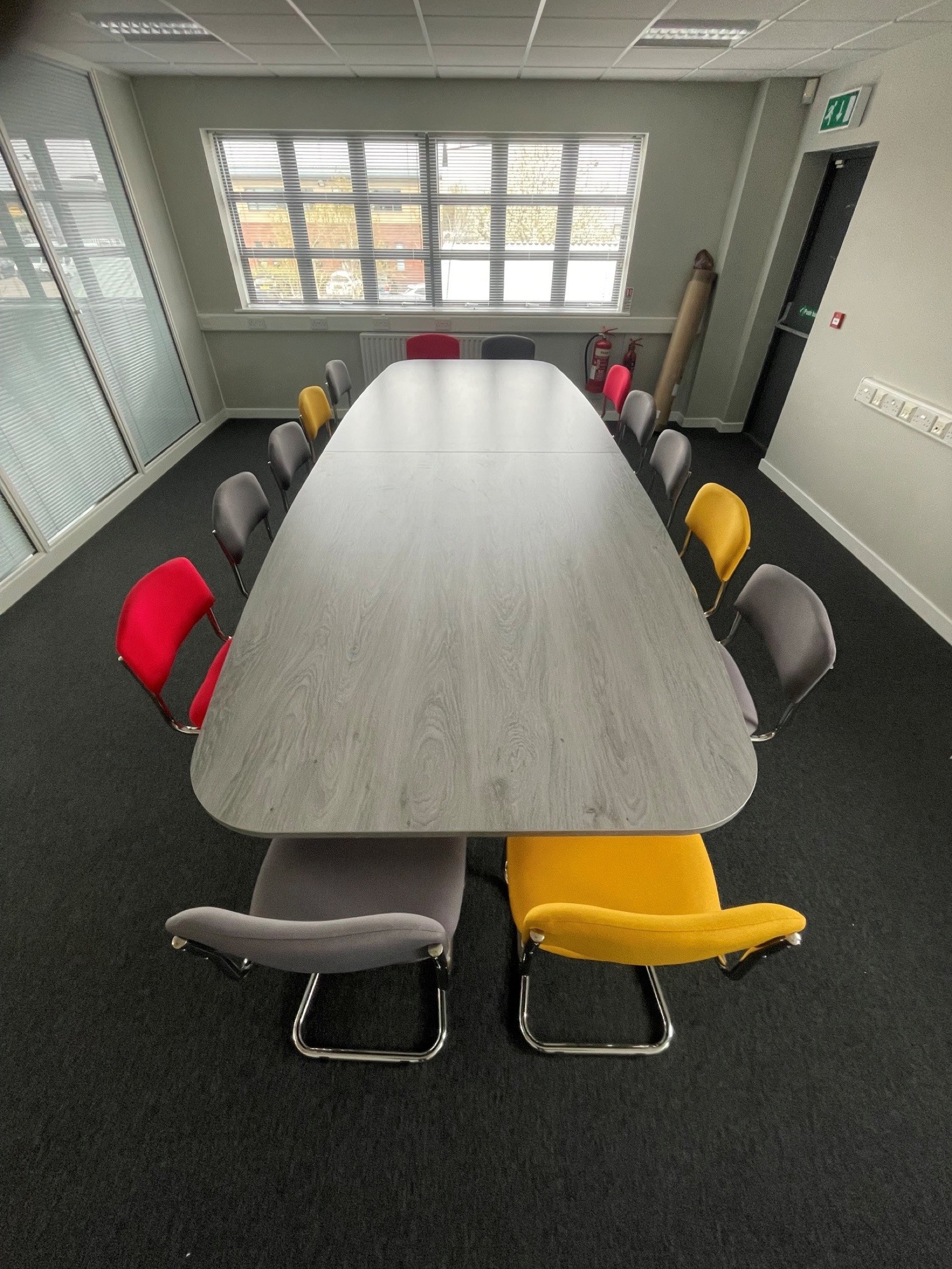 Classroom table with colourful chairs in a school room