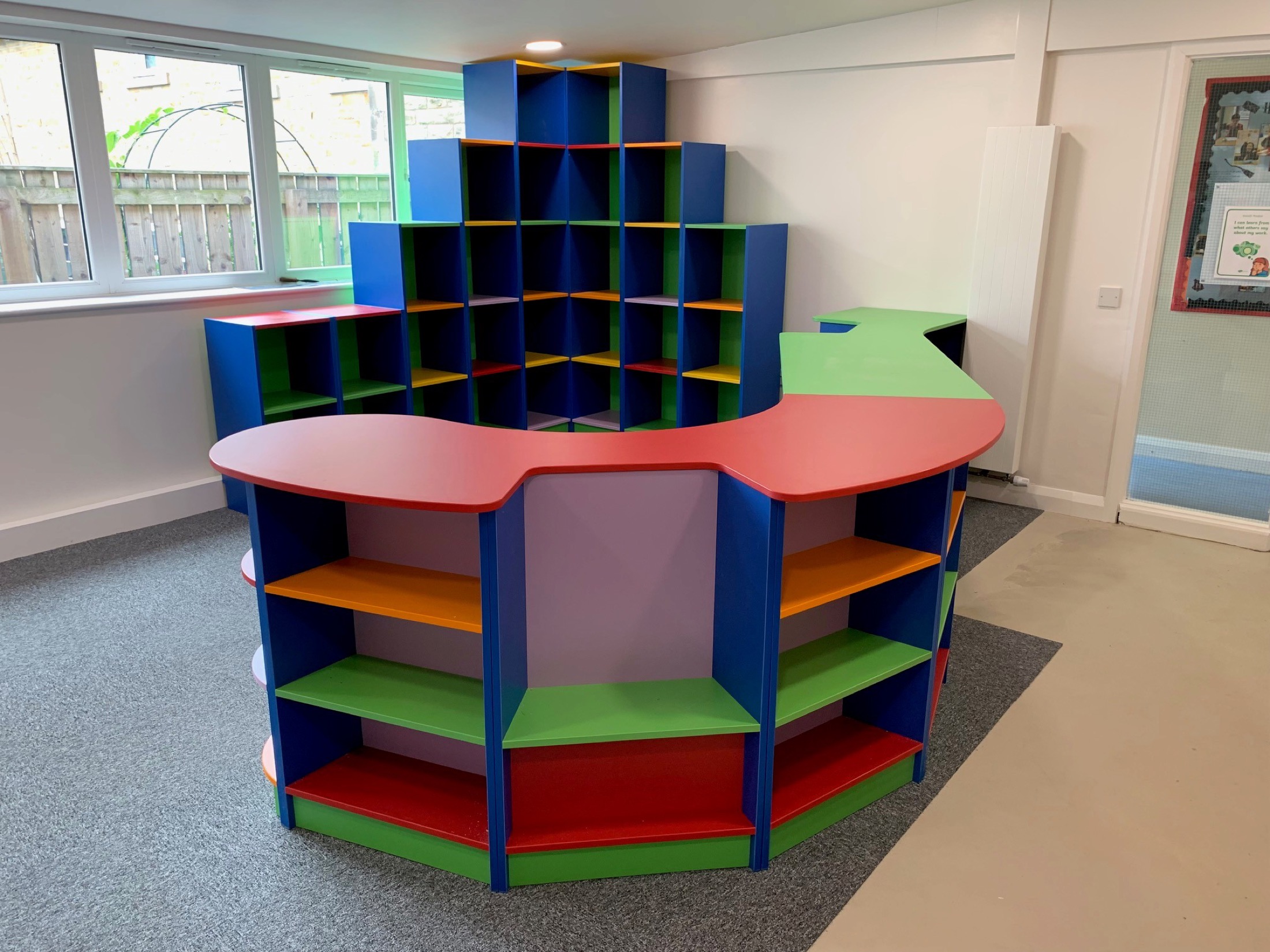 Colourful school library shelving with shaped display furniture